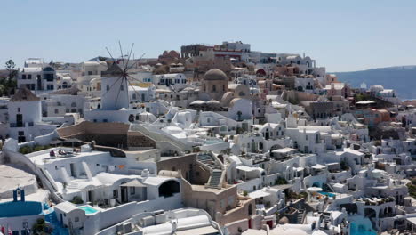 Oia-Village-In-Greece---Windmill-of-Oia-With-Luxury-Hotels-and-Typical-Houses-Painted-in-White-And-Blue