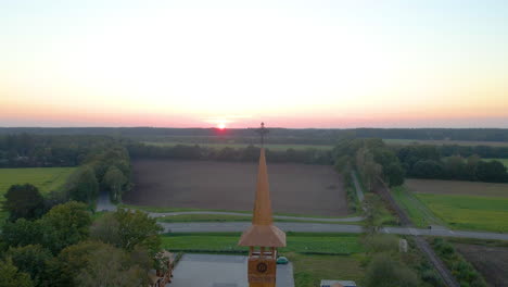 Church-Spire-At-The-Middle-Of-The-Green-Field-At-Dusk-In-Soegel,-Germany