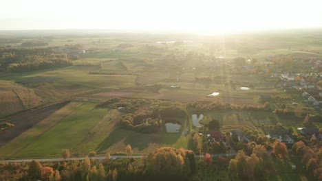 AERIAL:-Flying-Over-Green-Forest-and-Fields-in-Summer-in-Countryside-Village