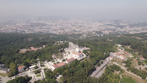 Aerial-high-Landscape-shot-over-Sameiro-Sanctuary-on-top-hill,-Braga-in-Distance