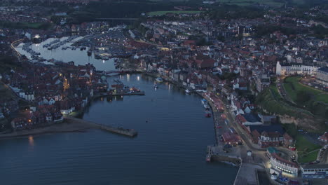 North-York-Moors,-Whitby-Harbour,-Drone-over-River-Esk-at-dawn-blue-hour
