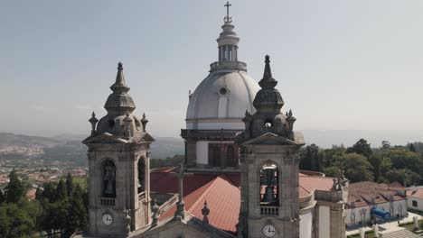 Close-up-pan-shot-capturing-the-clock-bell-towers-and-dome-monumental-sanctuary-of-sameiro