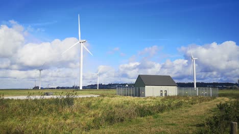 Blue-sky-renewable-wind-turbine-technology-spinning-on-British-sunny-countryside