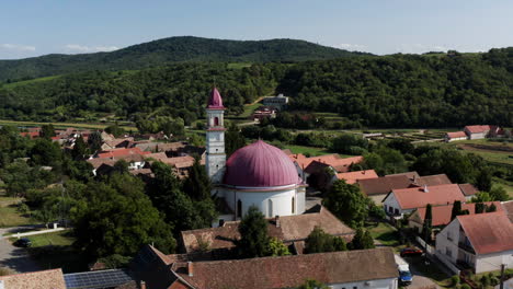 Church-In-The-Famous-Hungarian-Gastro-Village-In-Palkonya,-Hungary---aerial-pullback