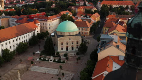 Famous-Mosque-Of-Pasha-Qasim-Victorious-On-Szechenyi-Square,-Pecs,-Hungary---aerial-drone-shot