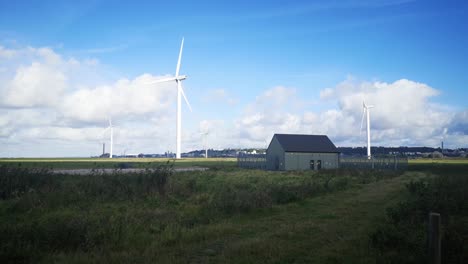 Blue-sky-renewable-wind-turbine-technology-rotating-on-British-countryside