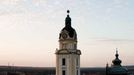 Clock-tower-overlooking-Pcs-City-in-Hungary-at-sunrise--Aerial