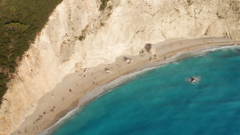 Tourist-On-Sandy-Shoreline-Of-Island-Cove-Beach-At-Porto-Katsiki-In-Lefkada-Island,-Greece