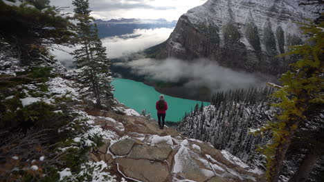 Lonely-Female-on-Lookout-Above-Lake-Louise,-Banff-National-Park-Alberta,-Canada
