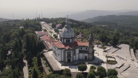 Aerial-drone-circling-ascendent-around-Sanctuary-of-Our-Lady-of-Sameiro-on-hilltop,-Braga