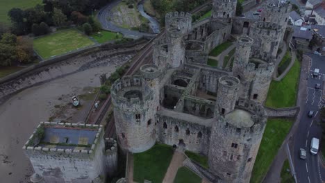 Medieval-Conwy-castle-walled-market-town-aerial-Birdseye-pull-back-view