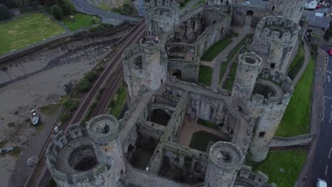 Medieval-Conwy-castle-walled-market-town-flying-above-stronghold-aerial-view