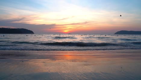 Parasailing-during-red-sunset-at-Langkawi-island,-Malaysia