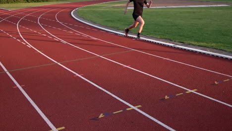 Male-Runner-Running-On-Red-Race-Track---slow-motion