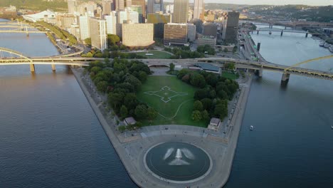 Aerial-view-of-the-Point-state-park-and-fountain,-sunny-morning-in-Pittsburgh,-USA---reverse,-drone-shot