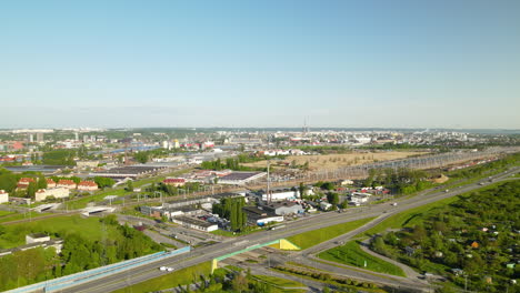 Aerial-view-of-Gdansk-city-landscape,-express-roads,-cargo-railway-terminal-on-sunny-day