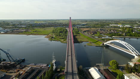 Vehicles-Driving-On-Third-Millennium-John-Paul-II-Bridge-Over-Martwa-Wisla-River-Beside-Railway-Bridge-In-Gdansk,-Poland