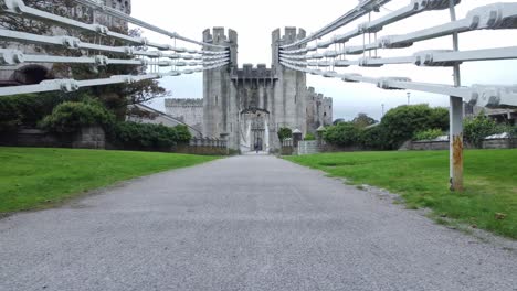 Moving-between-Conwy-castle-suspension-bridge-steel-engineering-cables-construction-pull-back-low-angle