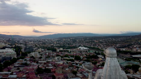 Aerial-fly-by-the-Mother-of-Georgia-on-top-of-Sololaki-hill-with-the-city-of-Tbilisi-below