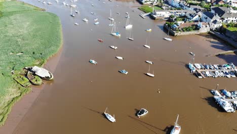 Aerial-Over-Sail-Boats-Anchored-In-Muddy-River-Exe