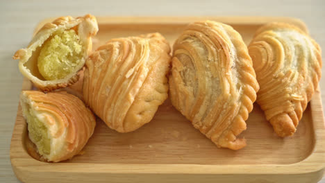 curry-puff-pastry-stuffed-beans-on-wooden-plate