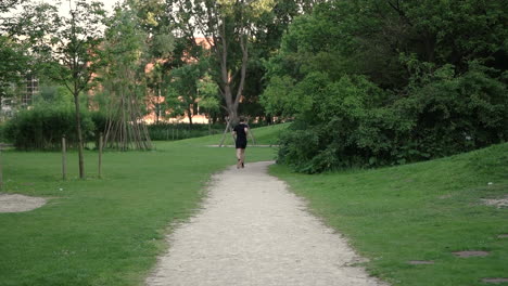 Young-Man-Running-At-Dirt-Path-In-The-Park