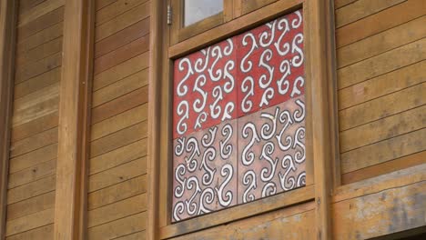Tribal-Pattern-on-Wood-Wall-At-The-Side-of-a-Wooden-Building