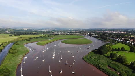 Aerial-rising-view-over-the-River-Exe-from-Topsham-looking-towards-Exeter-on-a-sunny-day