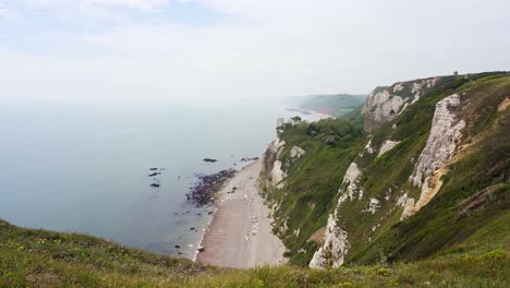 The-chalk-cliffs-and-rock-formations-of-Branscombe-beach-in-Devon-on-a-hazy-day