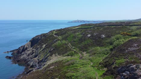Peaceful-Amlwch-Anglesey-North-Wales-rugged-mountain-coastal-walk-aerial-view-zoom-out