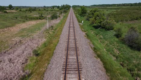Bird's-eye-view-travelling-down-train-tracks,-aerial-drone-shot