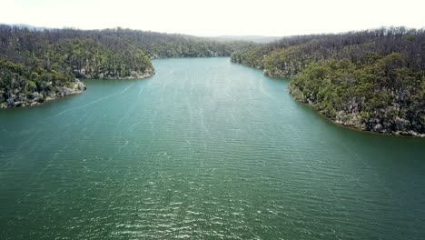 Descending-drone-footage-over-the-Mallacoota-Inlet,-in-eastern-Victoria,-Australia,-December-2020,-a-year-after-wildfires-affected-the-region