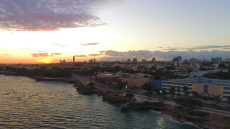 Aerial-circling-over-Santo-Domingo-waterfront-malecon-at-sunset-in-Dominican-Republic