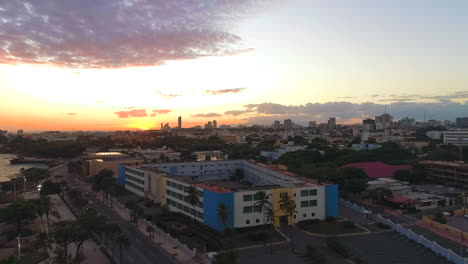 Aerial-sideways-over-Santo-Domingo-malecon-waterfront-at-sunset-in-Dominican-Republic