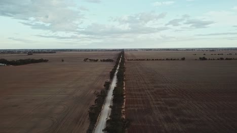 Aerial-footage-at-sunset-over-country-track-near-Berriwillock,-Victoria,-Australia,-May-2021