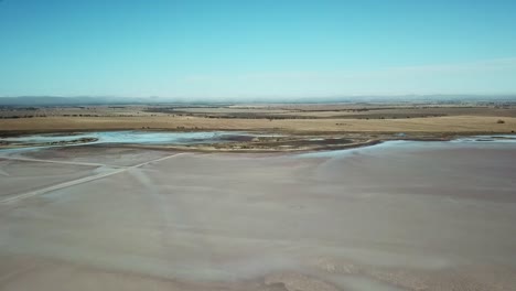 Drone-flies-over-the-salt-flats-of-Lake-Tyrell-with-views-of-surrounding-farmland,-in-north-west-Victoria,-May-2021