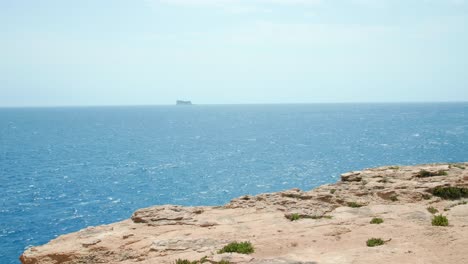 Island-of-Filfla-at-a-distance-shot-from-Wied-iz-Zurrieq,-the-island-is-a-bird-sanctuary-off-of-the-coast-of-Malta