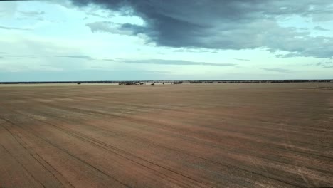 Reverse-drone-flight-over-dry-paddocks-near-Berriwillock,-Victoria,-Australia,-May-2021
