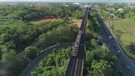 Metro-train-running-on-railway-bridge,-Santo-Domingo