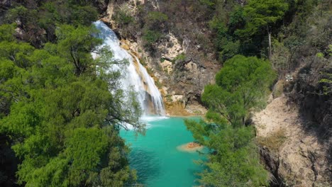 Beautiful-waterfall-in-tropical-jungle-mountainside,-4K-aerial-landscape