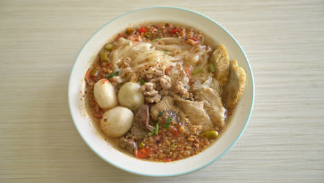 noodles-with-pork-and-meatballs-in-spicy-soup-or-Tom-yum-noodles-in-Asian-style