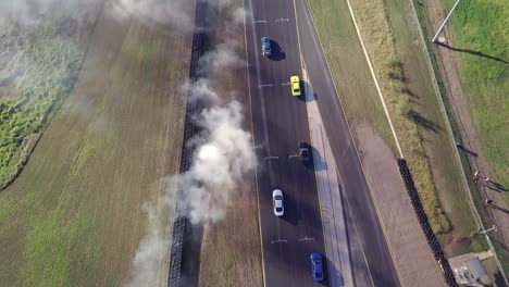 Bird's-Eye-View-Of-Cars-Drifting-Battle-On-Asphalt-Race-Track-With-Smoke-From-Burning-Tires-At-Sydney-Motorsport-Park-In-Australia---aerial-shot