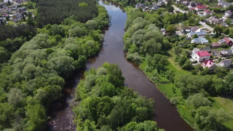 AERIAL-Ascending-Revealing-Flyby-over-the-river-in-a-small-town-Ukmerge-in-Lithuania