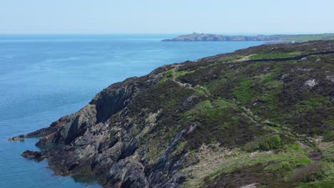 Peaceful-Amlwch-Anglesey-North-Wales-rugged-mountain-coastal-walk-aerial-view-slow-right-dolly-shot