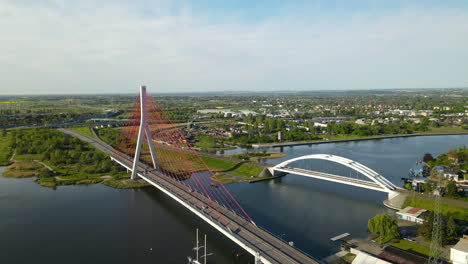 Aerial-View-Of-Third-Millennium-John-Paul-II-Bridge-Next-To-Railway-Bridge-Spans-On-Martwa-Wisla-River-In-Gdansk,-Poland