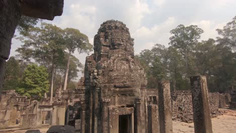 Reveal-of-carved-face-and-walls,-Angkor-Wat-stone-temple,-Cambodia