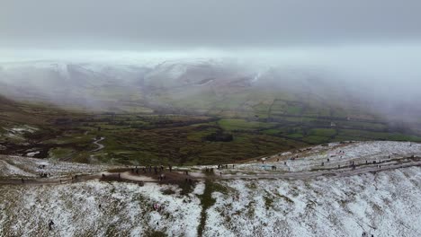 Aerial-view-Mam-Tor,-reveal-valley-in-Peak-District-mountain-winter-snow