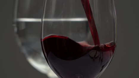 Close-up-slow-motion-pouring-red-wine-into-a-glass