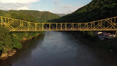 Drone-Aerial-View,-Footbridge-Above-Magdalena-River,-Near-Honda-City,-Colombia