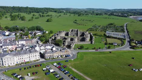 Sunny-touristic-Beaumaris-castle-town-aerial-view-ancient-Anglesey-fortress-landmark-descending
